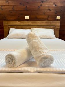 a rolled up towel sitting on top of a bed at Good Time 99 in Shezor