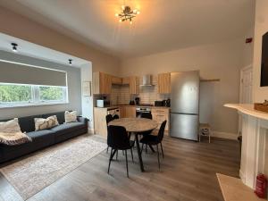 a kitchen and living room with a table and a couch at Castle Mount Apartments in Sandal and Walton +22 photos
