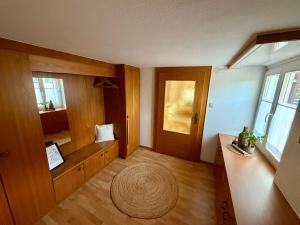 a living room with a door and a large rug at Ferienwohnung Lauterach in Lauterach