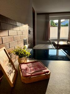 a room with a glass table with a box on the floor at Ferienwohnung Lauterach in Lauterach