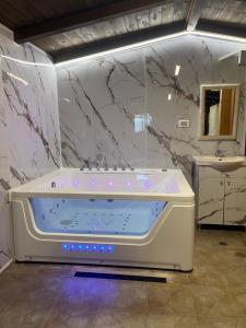 a bathroom with a large tub and a sink at Good Time 99 in Shezor