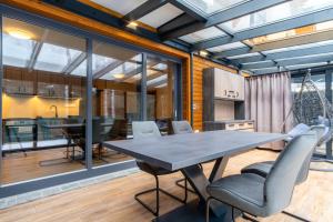 an open kitchen and dining room with a table and chairs at Vila DEDO in Tatranská Lomnica