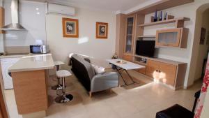 a small living room with a desk and a kitchen at Apartamento Lola 1 in Nerja