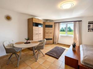 a living room with a table and chairs and a couch at Faraway Homes Studios Eberstalzell in Eberstalzell