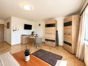 a living room with wooden cabinets and a table at Faraway Homes Studios Eberstalzell in Eberstalzell