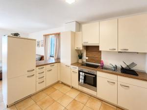 a kitchen with white cabinets and a sink at Faraway Homes Studios Eberstalzell in Eberstalzell +5 photos