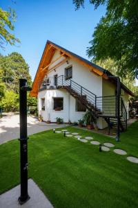a house with a green lawn in front of it at Rita Apartman in Balatonföldvár