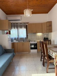 a kitchen with a table and a dining room at Maronia Villa in Maronia +30 photos
