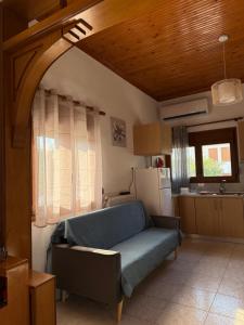 a living room with a couch in a kitchen at Maronia Villa in Maronia