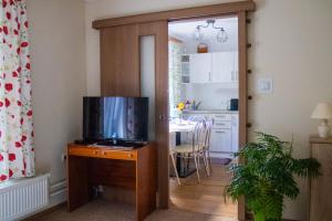 a living room with a television on a wooden table at Privat Kovacova in Žiar