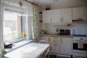 a kitchen with white cabinets and a window at Privat Kovacova in Žiar