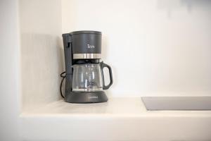 a black coffee maker sitting on a counter at Off the beaten path! Maisonette & Pool in Kithnos