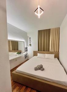 a bedroom with a large bed and a mirror at PARIS Luxury Center Apartment STRUGA in Struga
