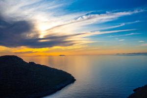 a sunset over a large body of water at Off the beaten path! Maisonette & Pool in Kithnos
