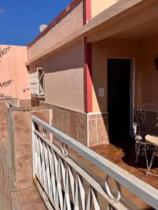 a balcony of a house with a table and a chair at Don Luis Alberto in El Puesto