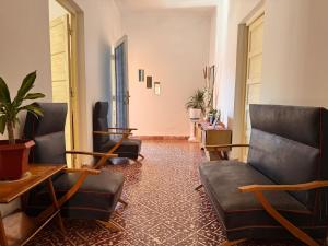 a living room with couches and chairs in a room at Don Luis Alberto in El Puesto