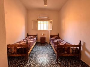 a room with two beds and a window at Don Luis Alberto in El Puesto