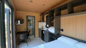a bedroom with a bed and a desk and a bed and a desk at Camping Alquézar in Alquézar