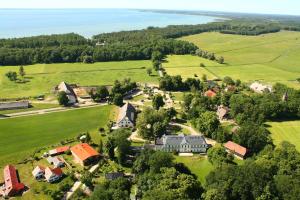an aerial view of a small town with houses and trees at Reetdachhotel - Residenz am Ostufer in Boek