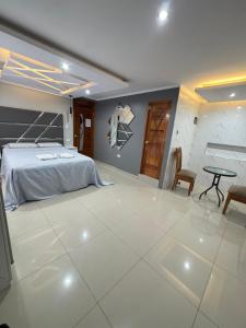 a bedroom with a bed and a table and chairs at Inti killa in Huánuco