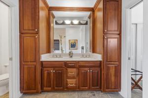 a bathroom with a sink and a mirror at Sea Manor in New Smyrna Beach +81 photos