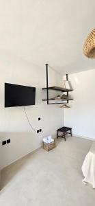 a living room with a tv hanging on the wall at Syros Blue Lagoon G2 in Galissas