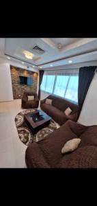 a living room with a couch and a table at Location par nuitée in Oran