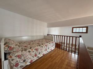 a bedroom with a bed with a floral bedspread at The Hidalga's cozy house in Arafo