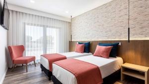 a hotel room with two beds and a chair at Private Alvor villa with pool and Jacuzzi in Alvor +38 photos
