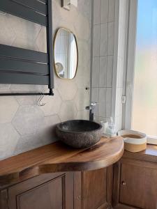 a bathroom with a stone sink and a mirror at Maison Gazel in Castres +25 photos