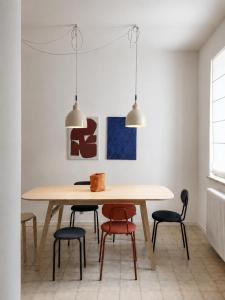 a dining room with a wooden table and chairs at Venzone dalla Finestra in Venzone