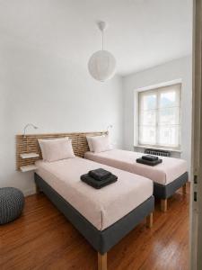 a bedroom with two beds and a window at Venzone dalla Finestra in Venzone