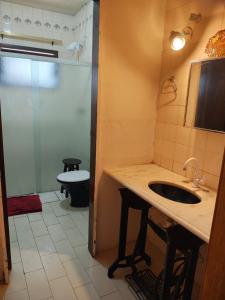 a bathroom with a sink and a toilet at Hostel Feel Home in Blumenau +48 photos