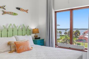 a bedroom with a bed and a large window at Sea Manor in New Smyrna Beach