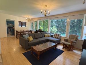 a living room with a couch and a table at Bright and Spacious Upper Level House, Great Area in North Vancouver