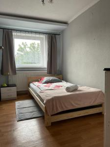 a bedroom with a large bed with a window at U Leona in Przeciszów
