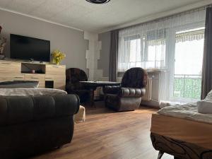 a living room with a couch and a table and chairs at U Leona in Przeciszów