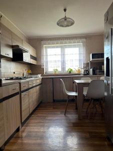 a kitchen with a table and a table and chairs at U Leona in Przeciszów