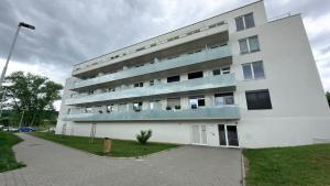 a white building with balconies on the side of it at Moderní apartmán Boskovice in Boskovice