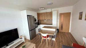 a small kitchen with a table and chairs in a room at Moderní apartmán Boskovice in Boskovice