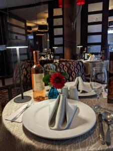 a table with a white plate and a bottle of wine at Blue Suites Hotel in Bogotá