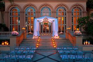 an aisle at a wedding in a building with lights at The Ritz-Carlton Naples in Naples +116 photos