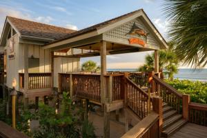 a house on the beach with a deck at The Ritz-Carlton Naples in Naples