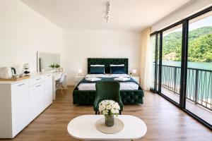 a bedroom with a bed and a view of the water at Vila Lago Verde in Zvornik