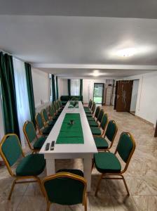 a conference room with a long table and chairs at Cabana Tonea in Avrig