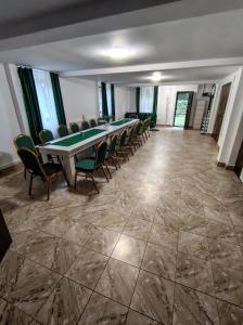 a conference room with a long table and chairs at Cabana Tonea in Avrig