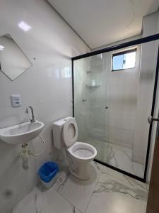 a bathroom with a shower and a toilet and a sink at Oeste Palace hotel in Brasília
