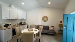 a kitchen and living room with a table and a couch at Provesende Douro Villas -Pateo Douro in Provesende