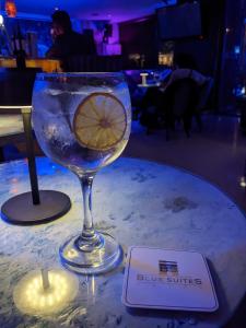 a wine glass with a lemon in it on a table at Blue Suites Hotel in Bogotá
