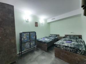a room with two beds in a room at Hostel VOYAGE in Batumi
